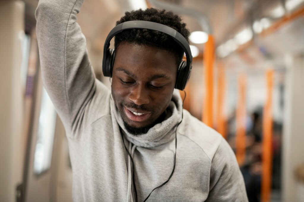 Man listening to headphones on the train