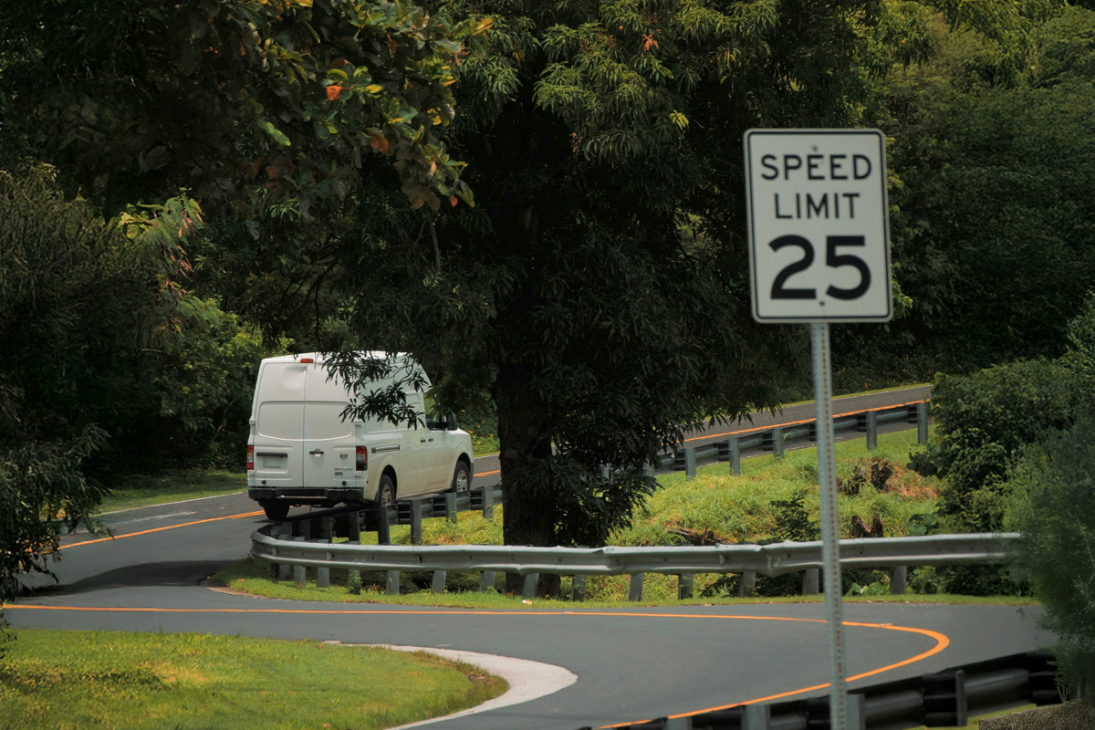 Car driving past a speed limit sign