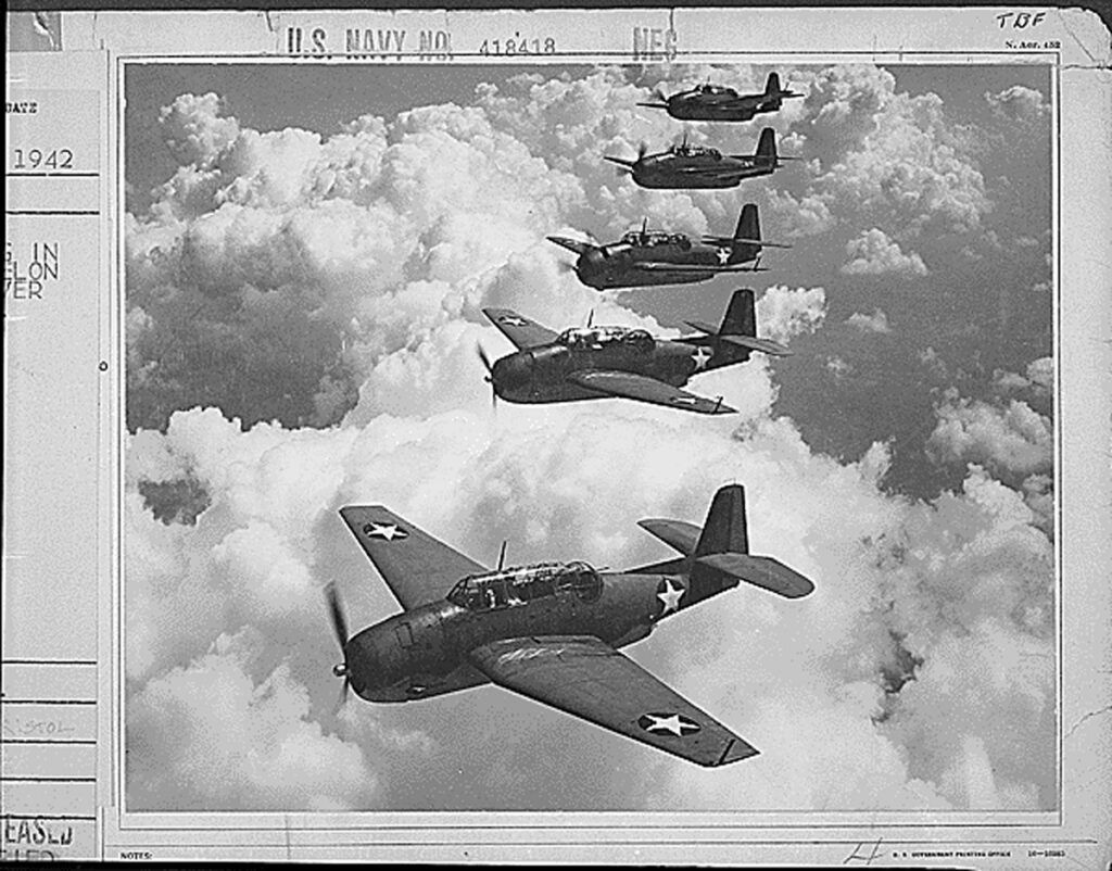 Black and white photo of 1940s war planes in the sky