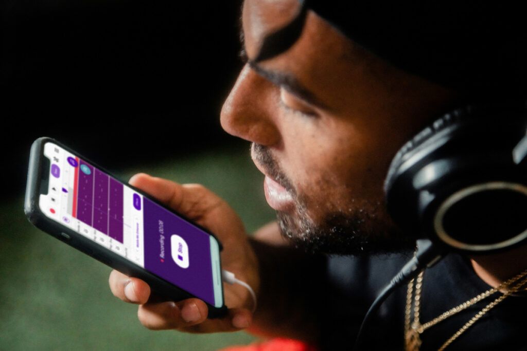 Person using headphones and recording app on their phone