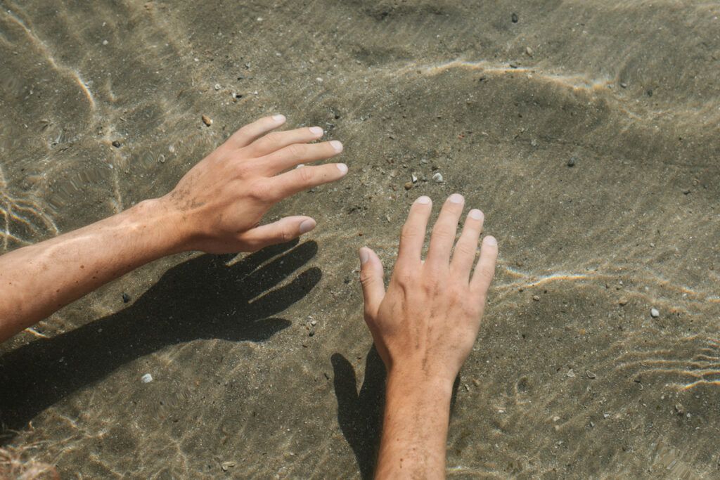 Two hands under the water