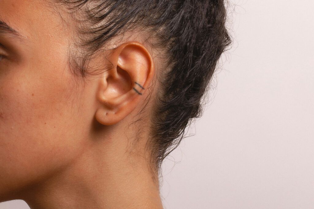Right profile of person focusing on their ear
