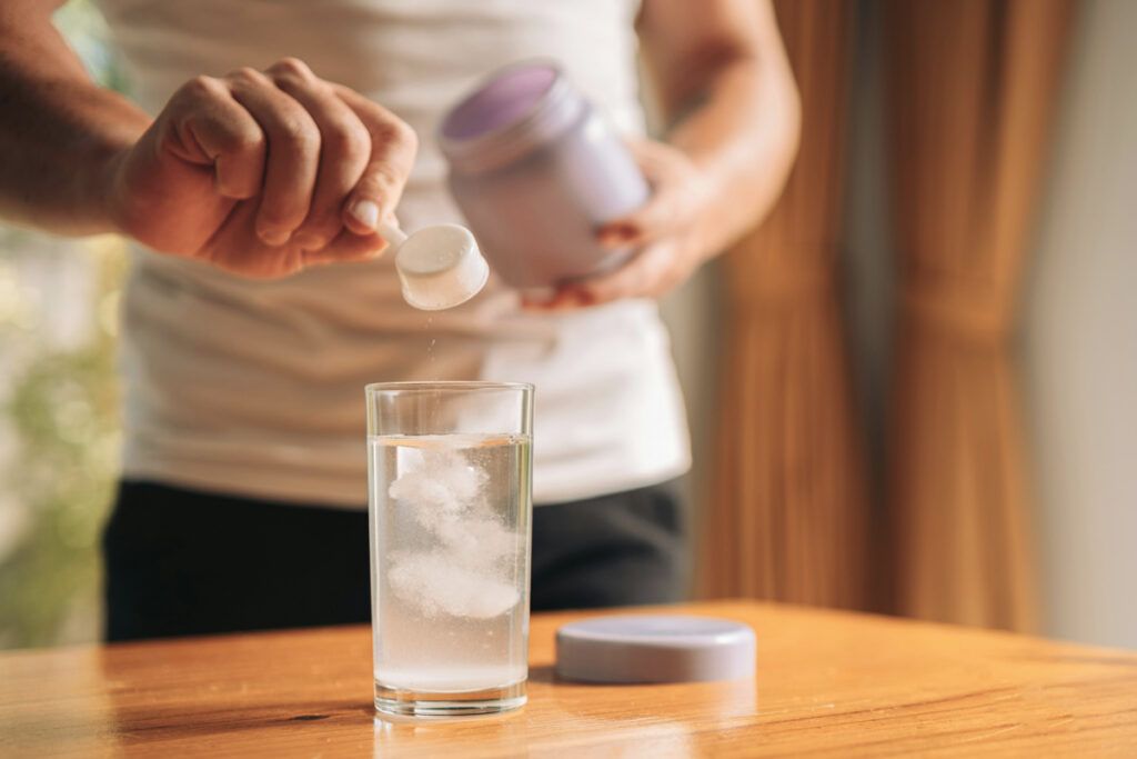 Person adding electrolytes to their drink
