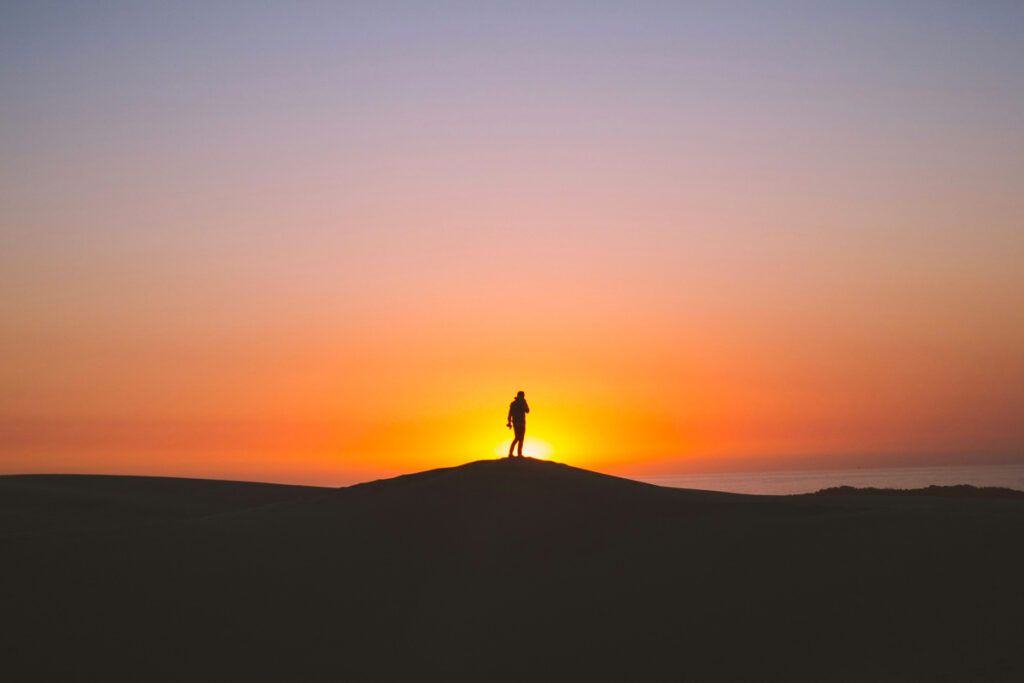 Person standing against a sunset