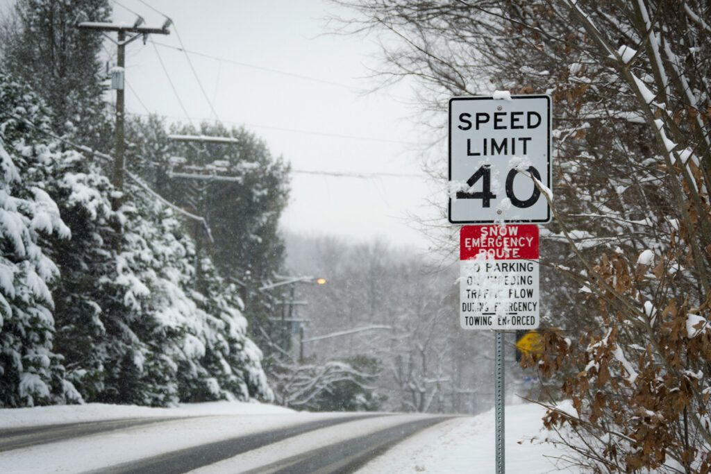 Speed limit sign in snowy weather