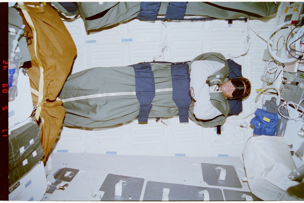 Sleep-restrained astronaut