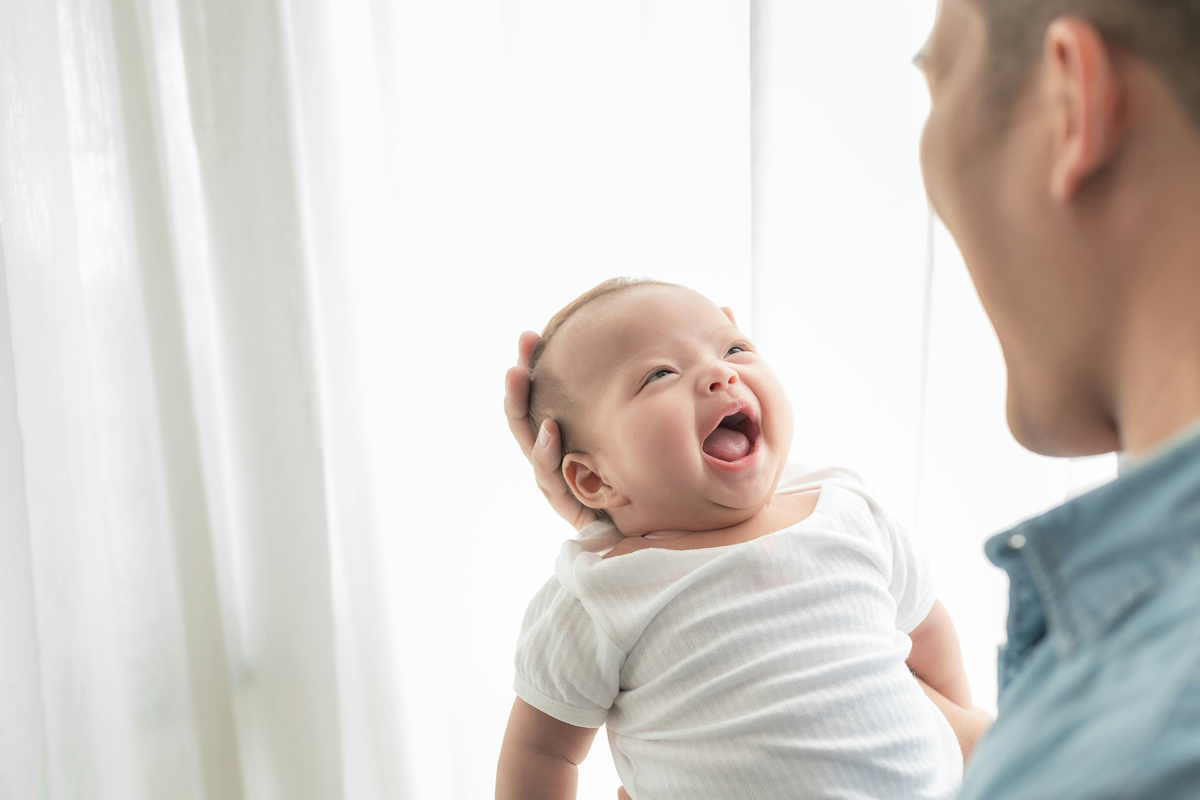 Person holding a laughing baby