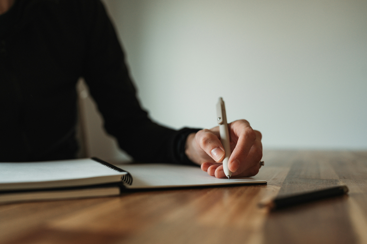 Person writing with left hand