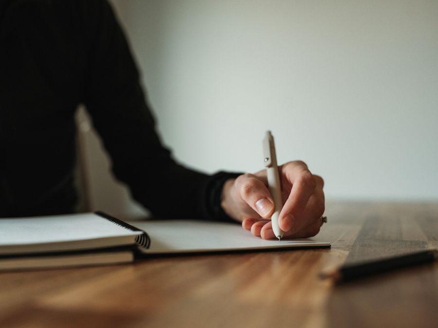 Person writing with left hand