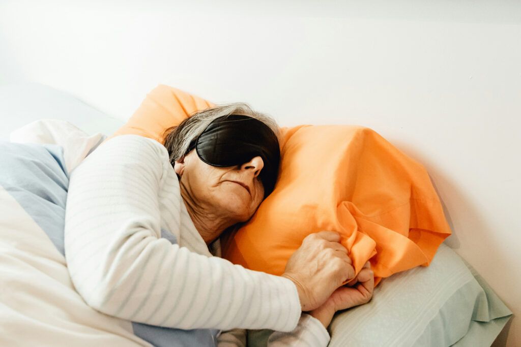 Person sleeping with a sleep mask
