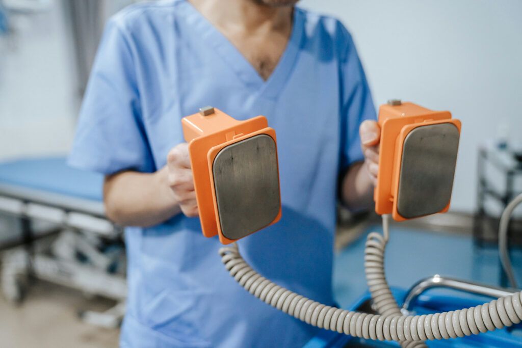 Doctor holding defibrillator paddles