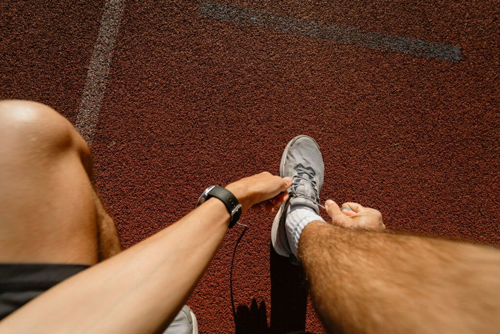 Person tying shoe during workout