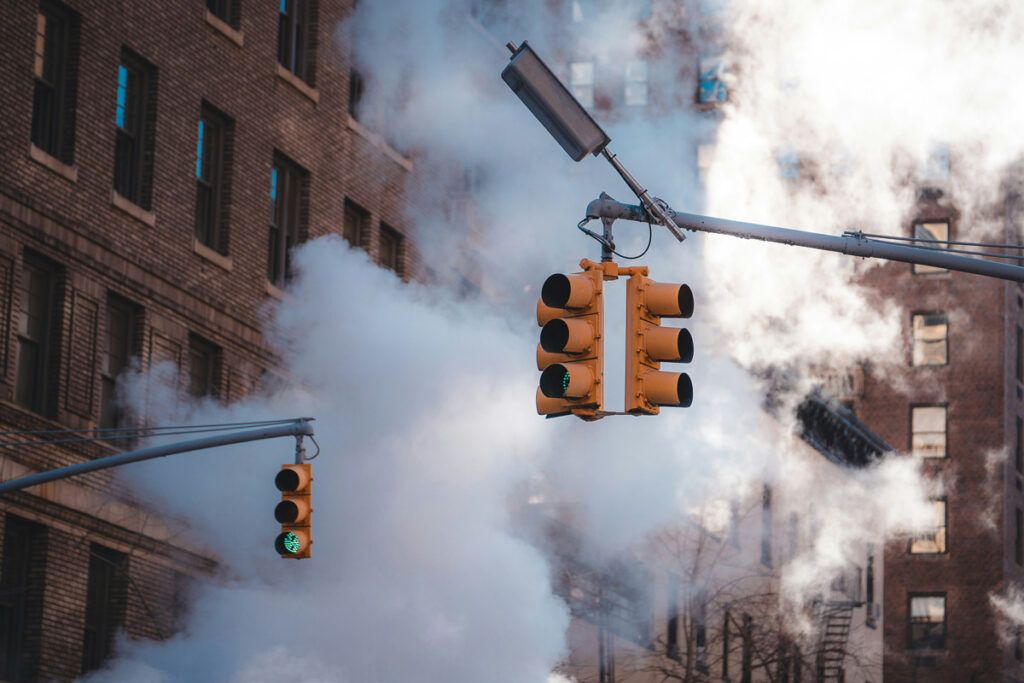 Traffic light hanging above city street