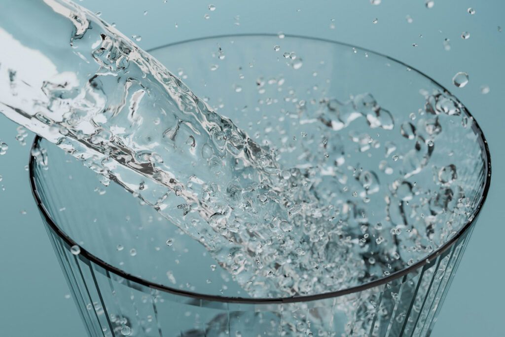 Water pouring in a glass with baking soda