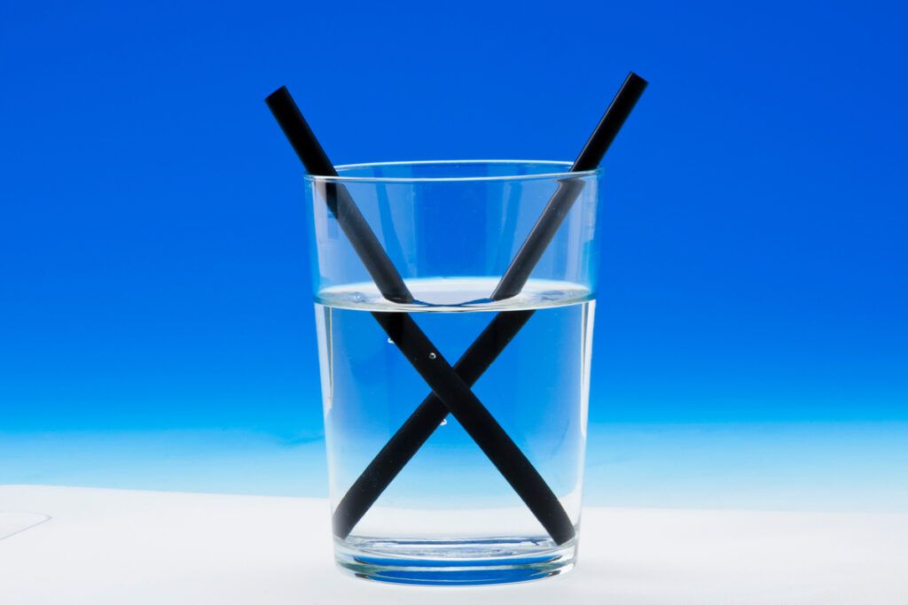 Two straws in a glass of water