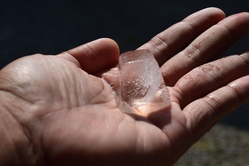 Ice cube in palm of hand