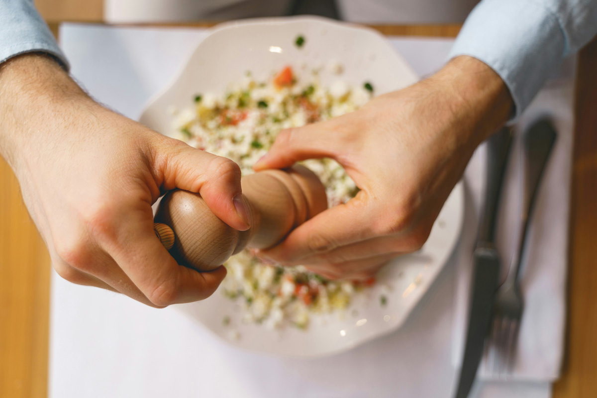 Grinding pepper onto a meal
