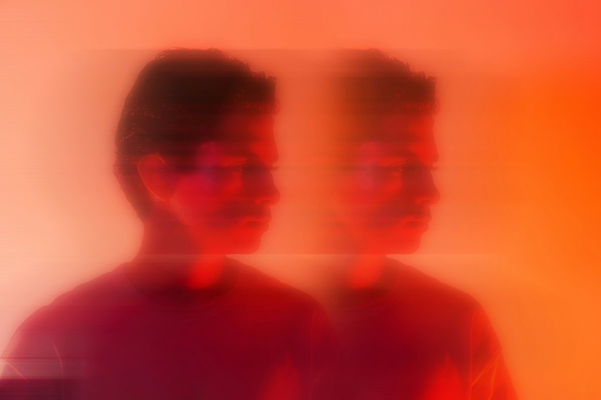 A blurred double image of a person's profile