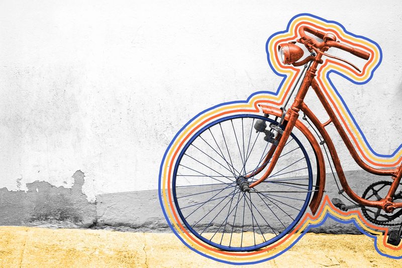 Rusty old bicycle leaning on a wall