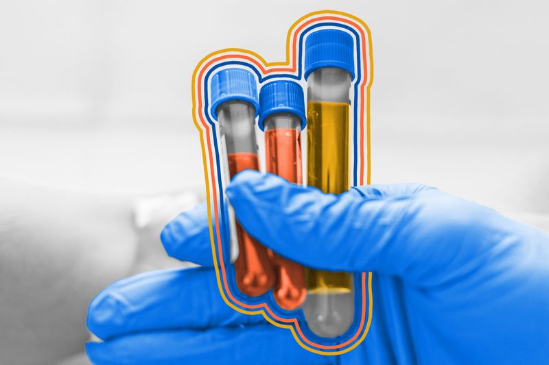 Blood test vials for blood groups held by nurse