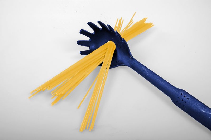 Bunch of pasta stuck through spaghetti server