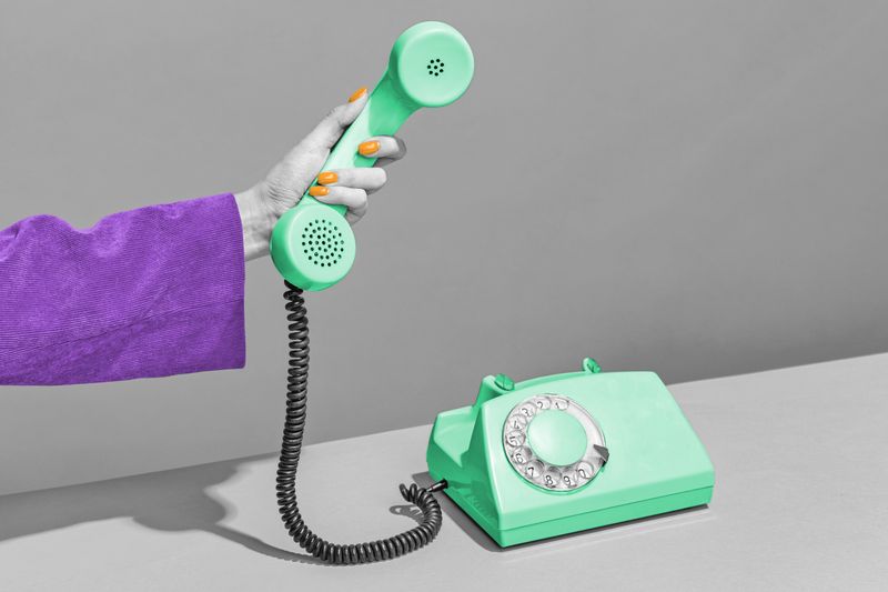 Hand holding receiver of a rotary phone