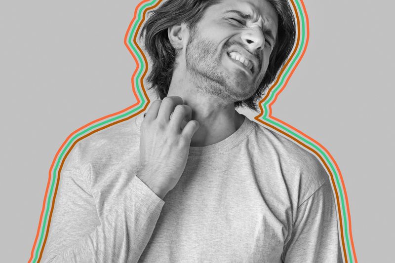 Uncomfortable man scratching at neck
