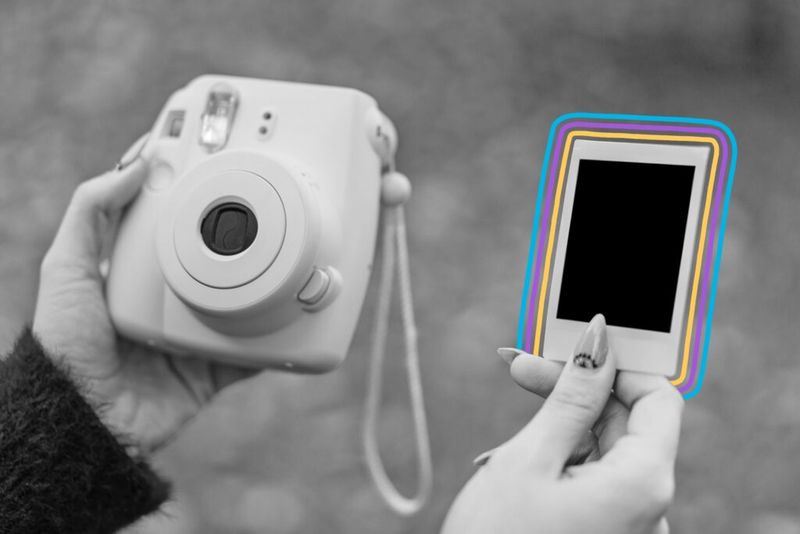 Modern Polaroid camera and printed photograph