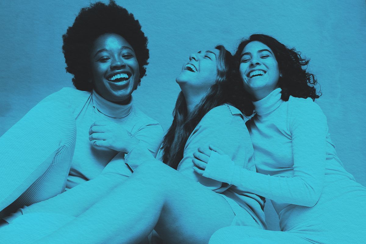 Three women laughing together