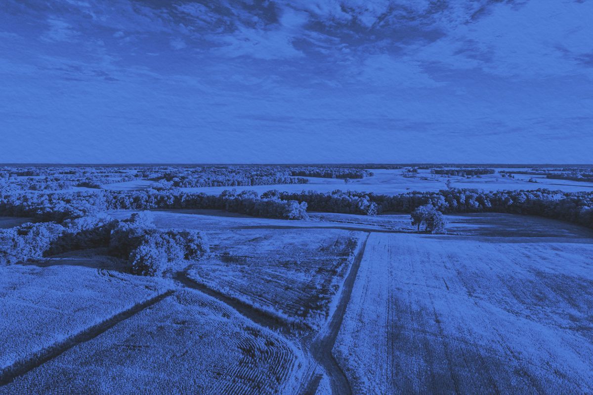 Aerial photo over a field and dirt road lanes