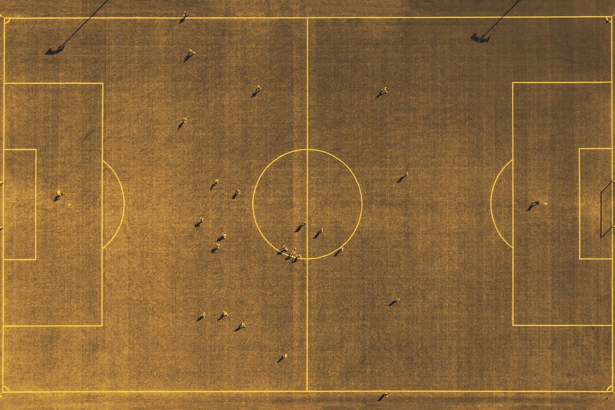 Aerial view of football field with player silhouettes