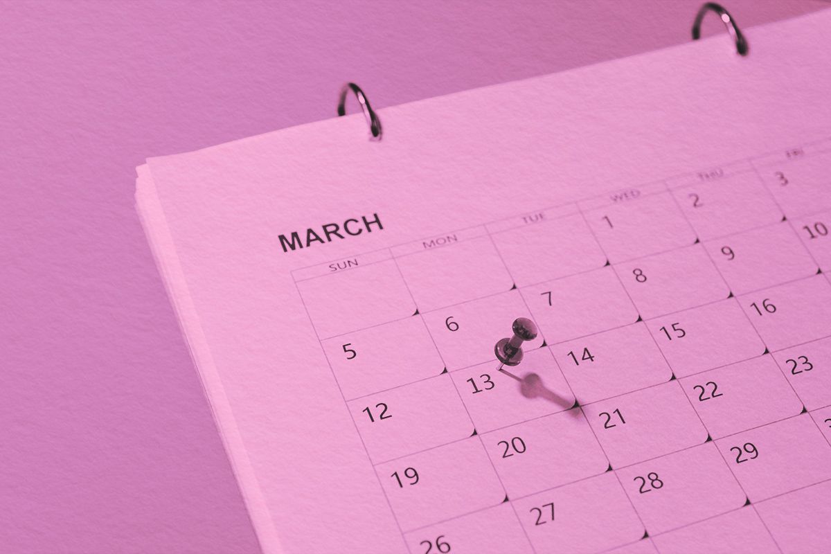 Red push pin on 13th day of March marked in calendar