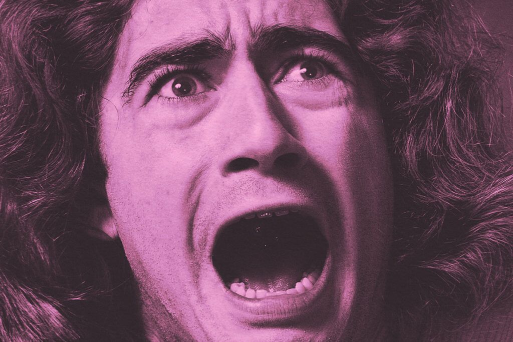 Close-up of a man screaming in terror