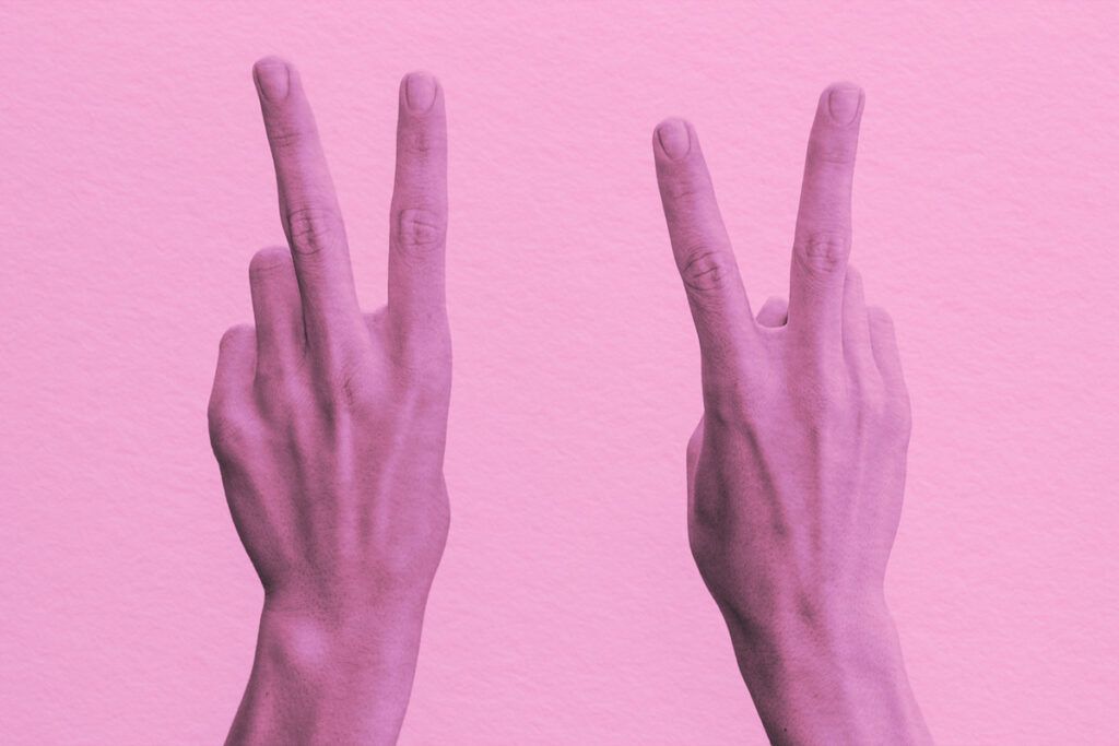 Two hands making the V sign with their fingers